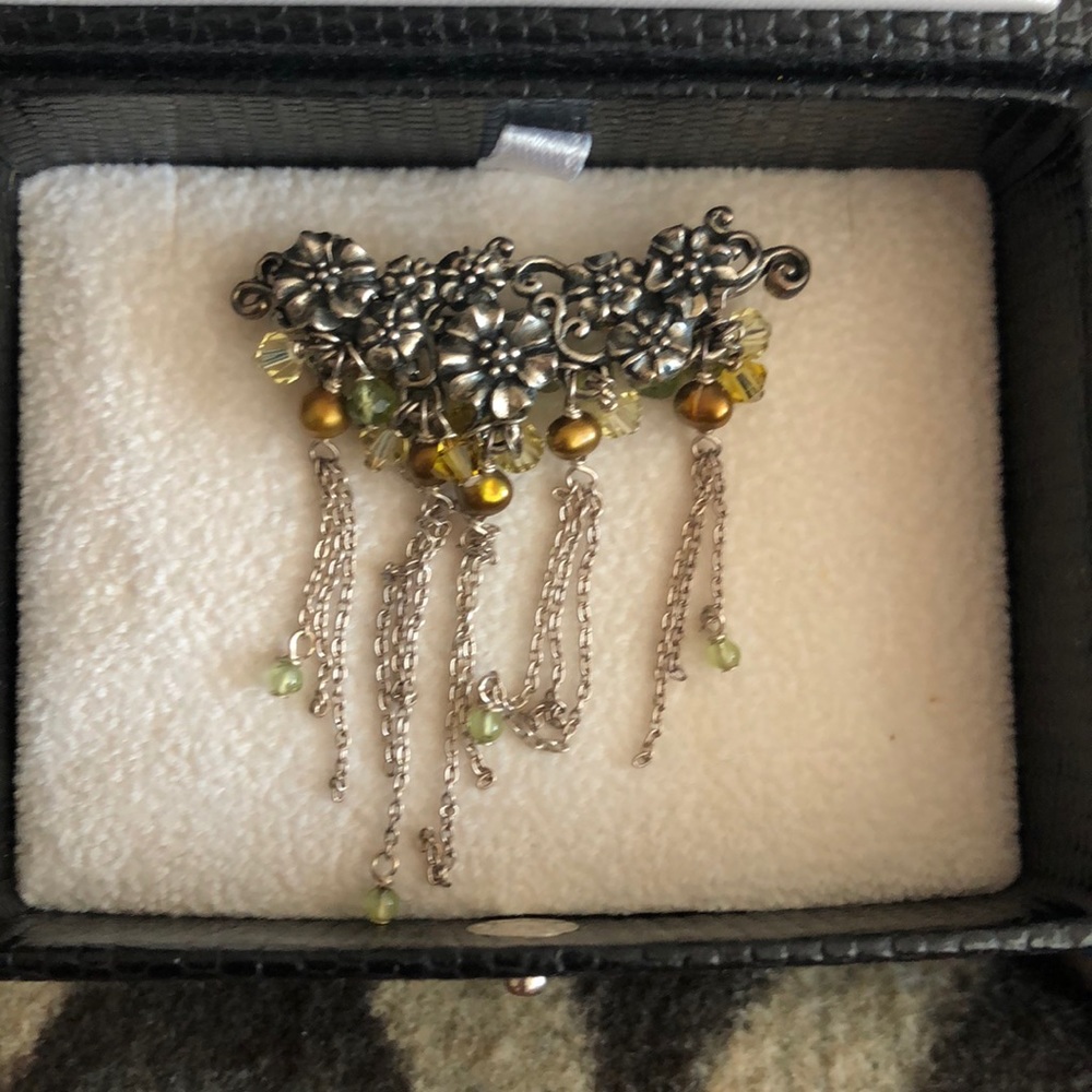 Floral brooch pin with hanging silver green beads.